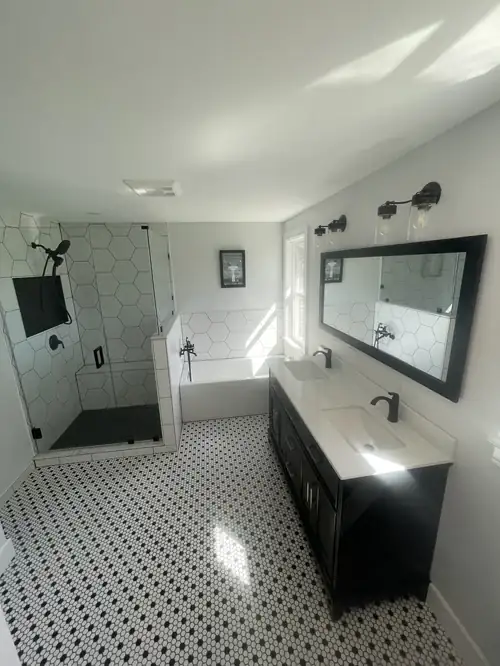 Swansea, MA bathroom remodel with a black double vanity, octagon mosaic floor tile and a frameless glass shower