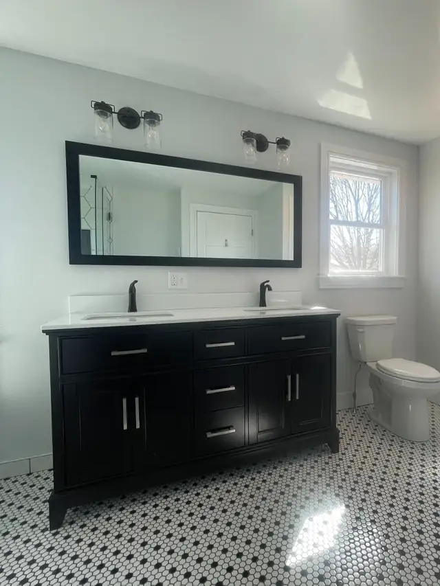 Bathroom remodel with green tile tub surround, white shiplap walls and marble-look floor tile