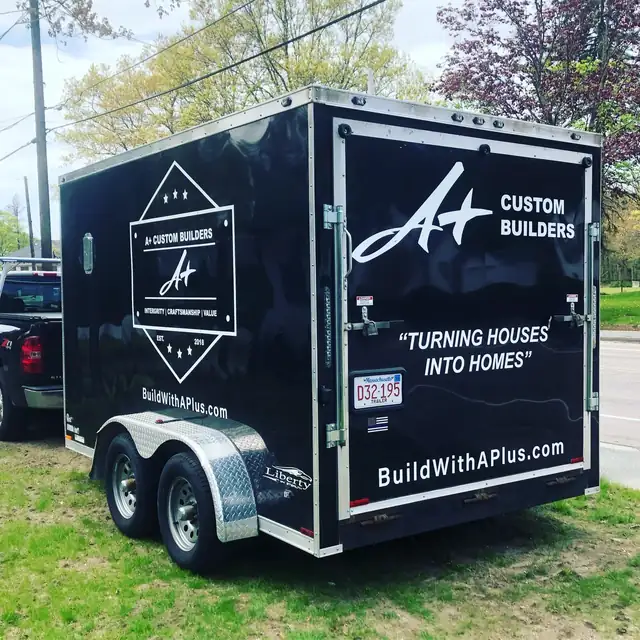 Black A+ Custom Builders job trailer with the company badge and the line Turning Houses Into Homes